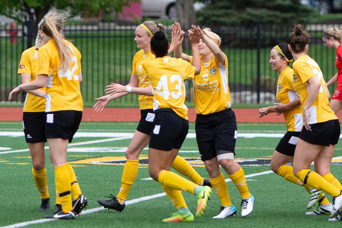 Rian Reid (43) celebrates her match-winning goal with the rest of the Eagles | Daniel Herlensky