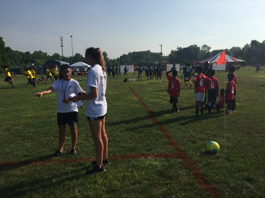 Lila Remache (left) and Hannah Sargent prepare to referee some under-10 4v4 soccer at the inaugural Columbus Nations Cup on July 14, 2018.