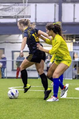 Columbus Eagles female soccer player keeps ball away from opposing team