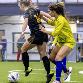 Columbus Eagles female soccer player keeps ball away from opposing team