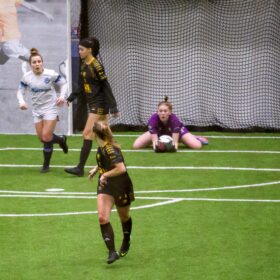Goalie makes save during PASL female soccer game